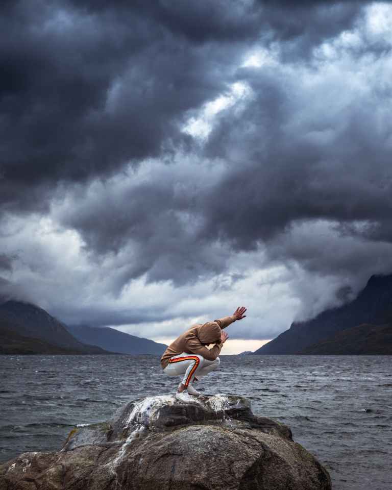 man doing dab position near beach