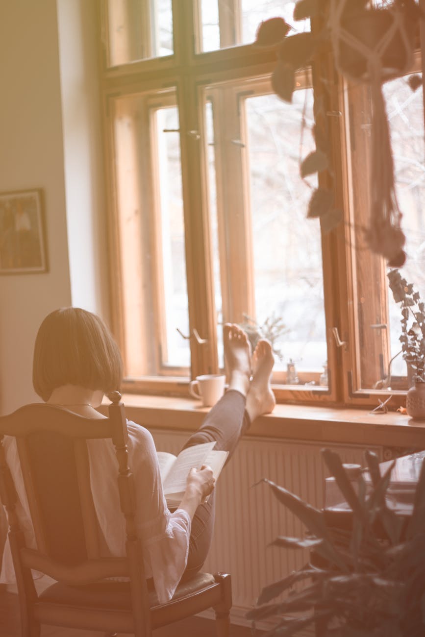 woman in white long sleeve shirt sitting on chair